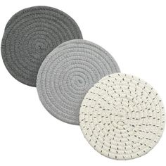 three round rugs with white and grey designs