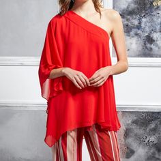 New Badgley Mischka Georgette One Shoulder Top. Size Medium Top, Bright Siam Red In Color, Fully Lined. This Loose Fitting, Breathable Summer Top Will Catch Their Eye As It Playfully Reveals A Single Shoulder. Feminine And Fun, This Top Is Perfect For Lunch Dates And Sunny Days. This Lightweight Blouse Drapes Elegantly From Your Shoulder To Your Upper Thigh, Featuring An Asymmetrical Design. Sheer Layers And Flowing Sleeves Perfect This Look. Perfect For At Home Entertaining Or A Special Night O Elegant Red Party Tops, Elegant Red Top For Evening, Elegant Red Tops For Evening, Elegant Red Evening Top, Red One-shoulder Party Top, Elegant Red Top For Wedding, Chic Red Holiday Tops, Chic Red One-shoulder Top, Elegant Holiday Cocktail Tops