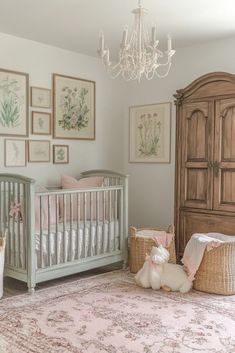 a baby's room with a chandelier, crib and other items