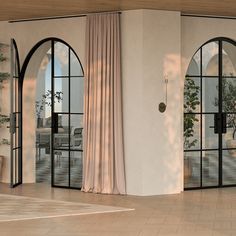 an open living room with sliding glass doors and potted plants on the wall next to it