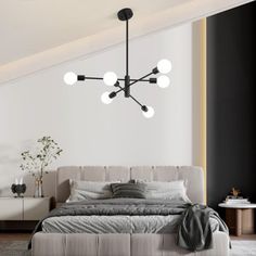 a bedroom with a bed, dresser and lamps on the wall above it in black and white colors