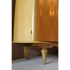 a wooden cabinet sitting on top of a carpeted floor