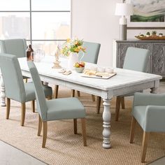 a dining room table with blue chairs around it