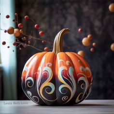 a painted pumpkin sitting on top of a table