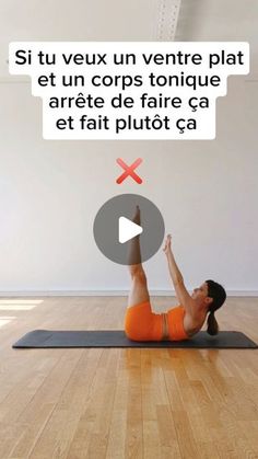 a woman in an orange top is doing yoga on a mat and has her hands up to the ceiling