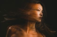 a woman with her hair blowing in the wind