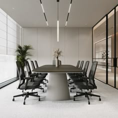 an empty conference room with black chairs and a round table