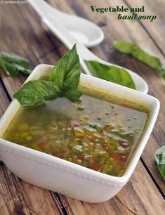 a white bowl filled with soup on top of a wooden table