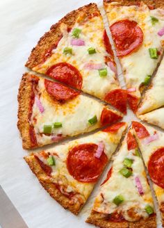 a pizza cut into eight slices with cheese, pepperoni and green onions on it