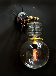 a light bulb hanging from the side of a wall with a cord attached to it