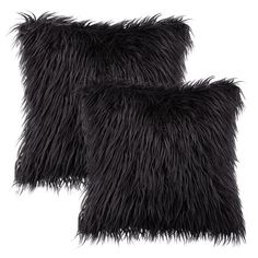 a black pillow with long, shaggy fur on the front and back of it's edges