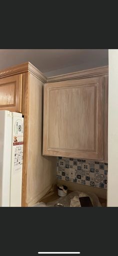 the kitchen cabinets are being painted white and have been stripped off with new woodgrain