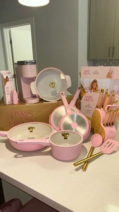 pink kitchenware and utensils sitting on a counter