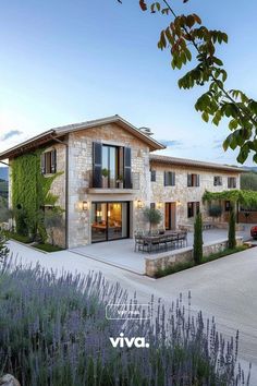 an image of a house that is in the middle of some lavender bushes and trees