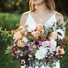 a woman holding a bouquet of flowers in her hands