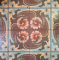 an artistic tile design with flowers and leaves on the floor in different colors, shapes and sizes