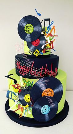 a three tiered cake decorated with vinyl records