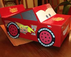 a cardboard race car sitting on top of a wooden table