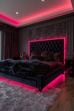 a large bed in a room with pink lights on the walls and carpeted floor