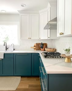 a kitchen with blue cabinets and white counter tops