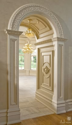 an open doorway with a chandelier hanging from the ceiling