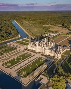 an aerial view of a castle surrounded by trees