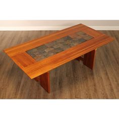 a wooden table sitting on top of a hard wood floor