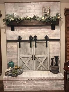 the fireplace is decorated with greenery and flowers on it, along with other decorations