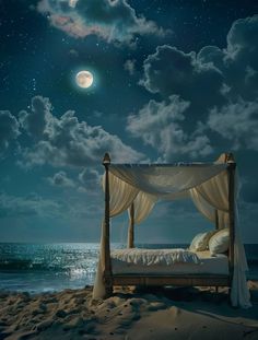 a bed sitting on top of a sandy beach under a full moon