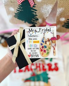 a person holding up a card with an ornament on it that says mr and mrs fridl