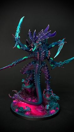 a purple and green painted warhammer with two large swords on it's head