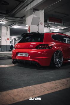 a red car parked in a parking garage