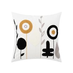 a white pillow with black, yellow and grey flowers on the front is featured in this image