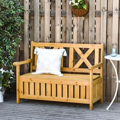 a wooden bench sitting next to a potted plant