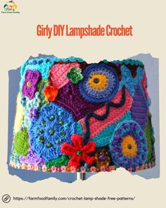 a colorful crocheted lamp shade with flowers and leaves on the bottom, made from yarn