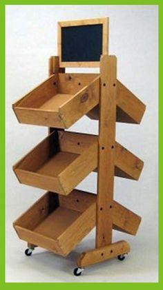 a wooden shelf with chalkboard on top and wheels attached to the bottom, in front of a white background