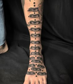 a person has a tattoo on their foot with many circles and dots in the middle