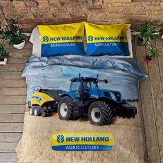 a bed with two blue tractors on it and yellow pillow cases next to each other