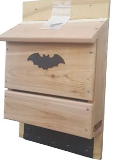 a wooden box with a bat cut out on it's front and bottom lid