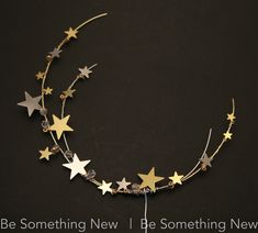 a gold and silver star headband with crystal beads on black background text reads be something new be something new