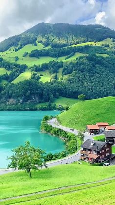 a lake surrounded by lush green hills and trees