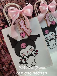 two hello kitty bags with pink bows on them