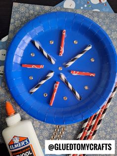 a blue plate with toothbrushes and glue on it