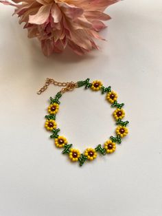 Pretty sunflower design  encompassed in anklet  Yellow and green glass seed beads Chocolate glass pearl bead centers finished with lobster clasp & extension chain and charm Length option available  shipping Free delivery on all uk orders International is by Airmail,please see listings for time scale I am not a big business but a one woman operation. I pride myself with attention to detail and strive to offer a swift and efficient service. If anything is not to your complete satisfaction I would appreciate to be given the opportunity to put it right BEFORE feedback is left. Any problems: Please send me a message before opening a case as most problems can be quickly & easily resolved . Yellow Seed Bead Bracelet, Summer Flower Shaped Beaded Chain Jewelry, Yellow Dainty Jewelry For Summer, Dainty Yellow Jewelry For Summer, Dainty Yellow Summer Jewelry, Summer Yellow Beaded Bracelets With Tiny Beads, Summer Flower Jewelry With Tiny Beads, Summer Flower-shaped Jewelry With Tiny Beads, Handmade Yellow Beaded Bracelets For Summer