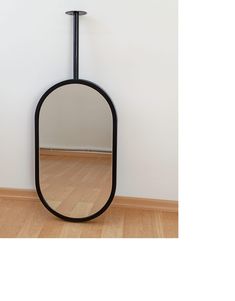 a mirror sitting on top of a wooden floor