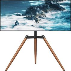 an easel with a photo on it in front of a white background and wooden tripod legs