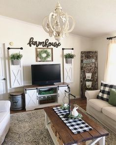 a living room filled with furniture and a flat screen tv on top of a wooden table