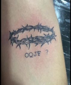 a tattoo with the word oeuf written on it and barbed wire around it