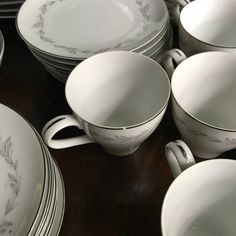 a table topped with lots of white dishes