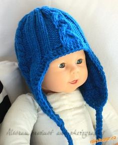 a doll wearing a blue knitted hat